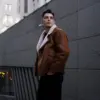Man wearing a brown jacket with a stylish casual look