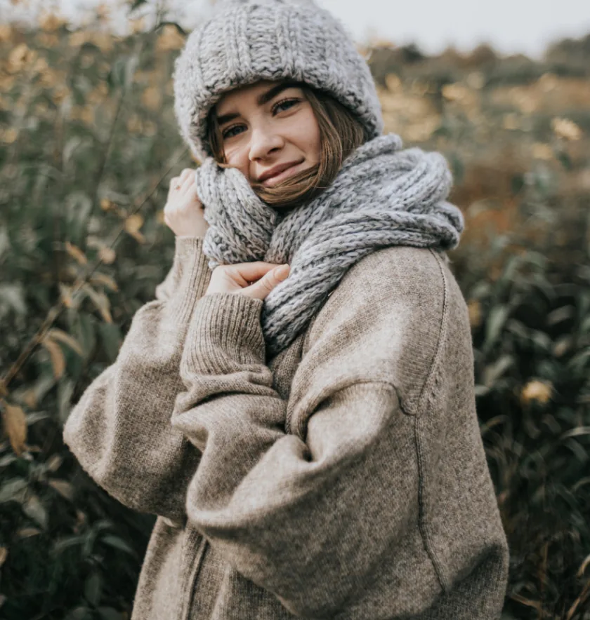 Woman wearing winter clothes covering head, hands, and body
